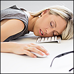 Exhausted woman sleeping in front of computer